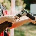 man-opens-shotgun-bolt-after-one-shot-with-smoke